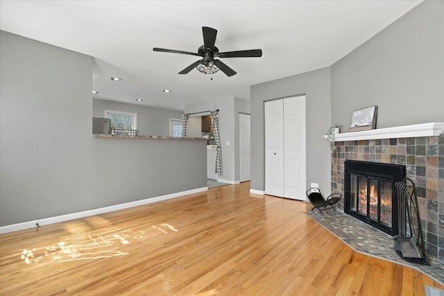 24860 W Forest Dr, Lake Villa, IL 60046 - unfurnished living room with wood finished floors, a fireplace, baseboards, ceiling fan, and recessed lighting