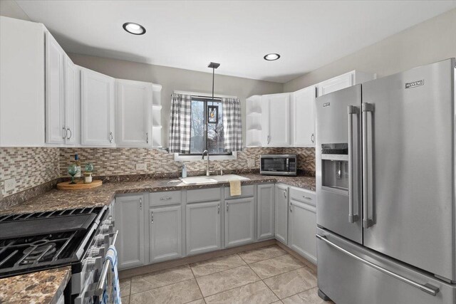 24860 W Forest Dr, Lake Villa, IL 60046 - kitchen featuring appliances with stainless steel finishes, a sink, decorative backsplash, light tile patterned floors, and white cabinets