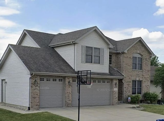 traditional-style home with brick siding, concrete driveway, and roof with shingles