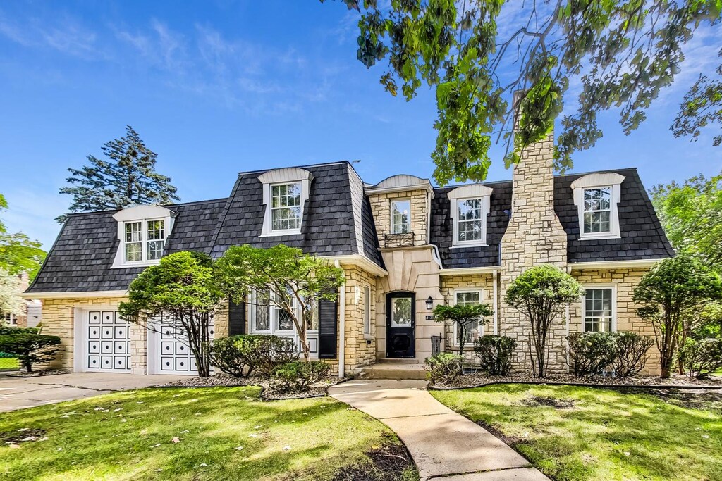 8122 Edgewater Rd, North Riverside, IL 60546 - view of front facade with mansard roof, driveway, a front yard, and a chimney