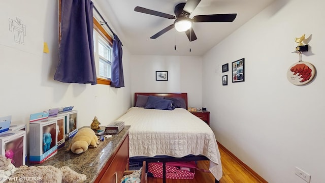 bedroom with ceiling fan and wood finished floors
