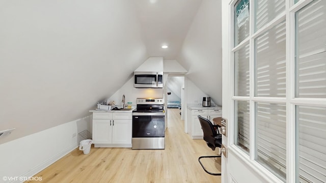 office area featuring baseboards, lofted ceiling, light wood-style floors, and recessed lighting