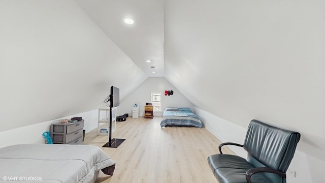 bedroom with lofted ceiling, wood finished floors, and recessed lighting