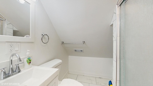 full bath featuring baseboards, marble finish floor, toilet, a sink, and vaulted ceiling
