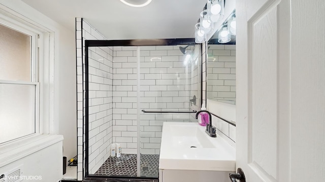 bathroom featuring vanity and a shower stall