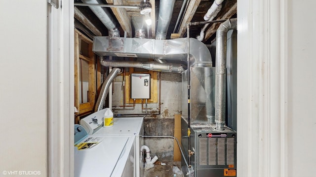 utility room with water heater and washer and dryer