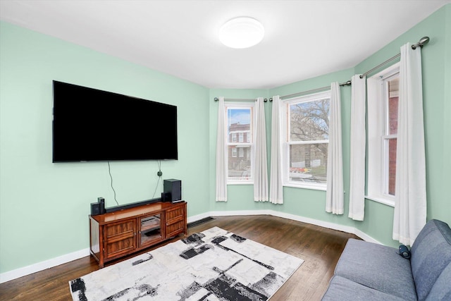 living room with baseboards and dark wood-style flooring