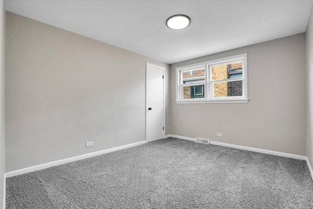 carpeted empty room with baseboards and visible vents