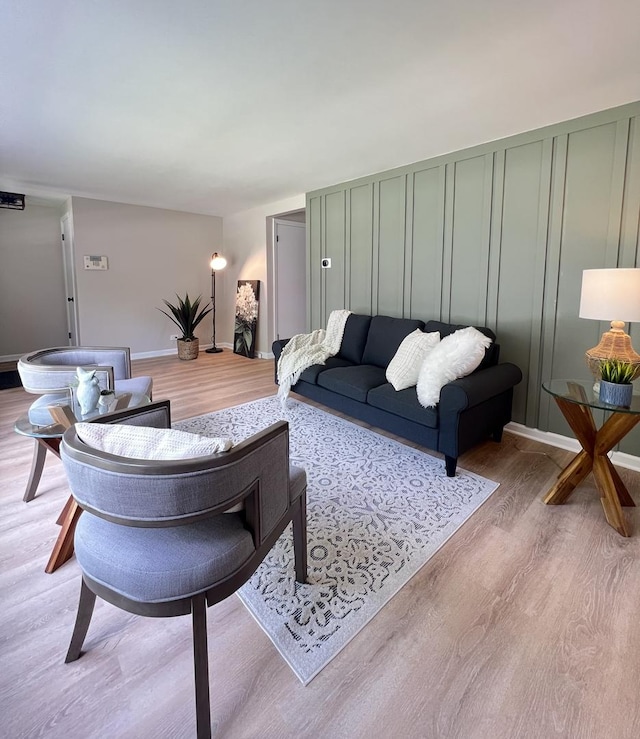 10854 S Union Ave, Chicago, IL 60628 - living room featuring wood finished floors, a decorative wall, and baseboards