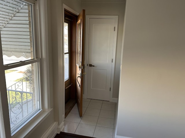 interior space featuring baseboards and light tile patterned floors