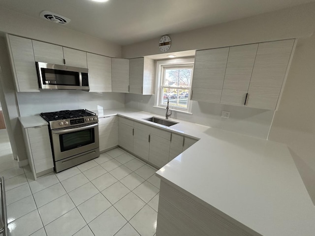 kitchen with visible vents, light countertops, a sink, and appliances with stainless steel finishes