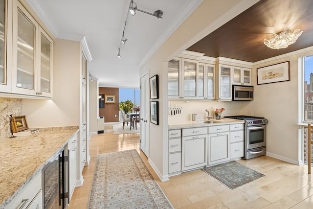 1555 N Dearborn Pkwy Unit 25Ab, Chicago, IL 60610 - kitchen with a sink, stainless steel appliances, wine cooler, rail lighting, and light stone counters