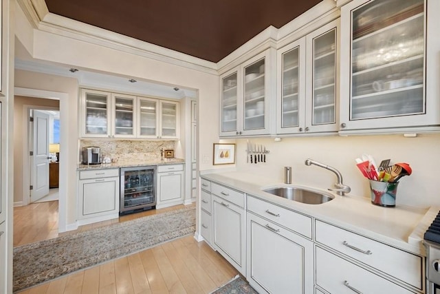 1555 N Dearborn Pkwy Unit 25Ab, Chicago, IL 60610 - bar featuring decorative backsplash, light wood-style floors, ornamental molding, a sink, and wine cooler