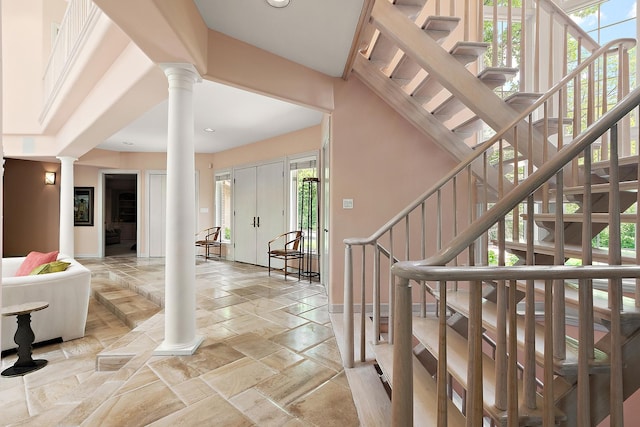 621 Chatfield Rd, New Lenox, IL 60451 - entryway with ornate columns, stairs, stone tile floors, baseboards, and recessed lighting