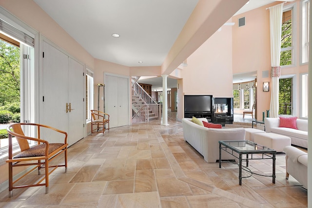 621 Chatfield Rd, New Lenox, IL 60451 - living area with decorative columns, stairs, and stone tile floors