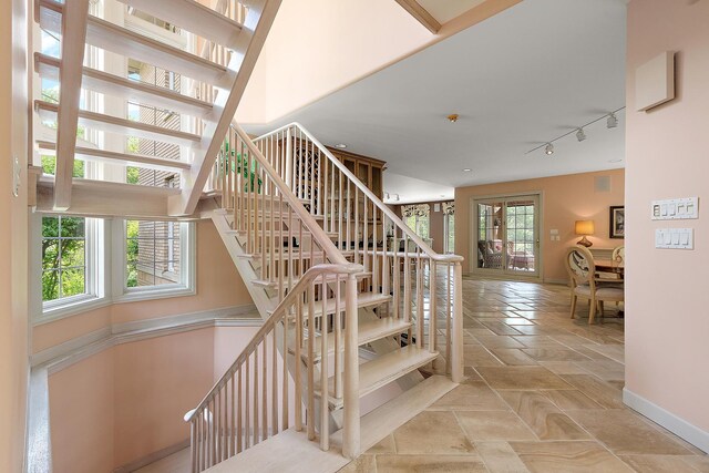 621 Chatfield Rd, New Lenox, IL 60451 - staircase with baseboards, track lighting, and stone tile floors