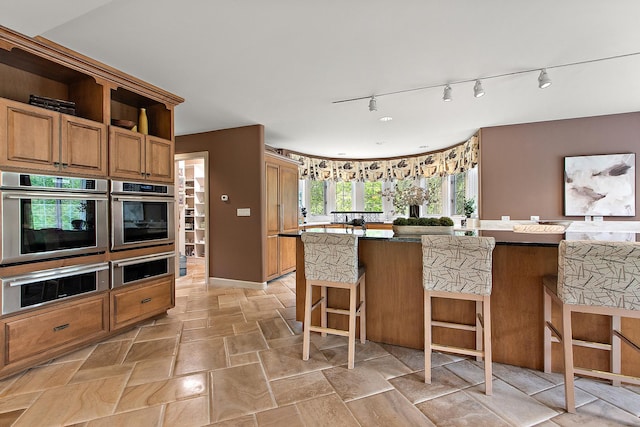 621 Chatfield Rd, New Lenox, IL 60451 - kitchen with oven, track lighting, a kitchen bar, and a warming drawer