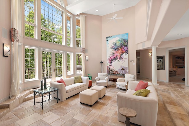 621 Chatfield Rd, New Lenox, IL 60451 - living area featuring a towering ceiling, decorative columns, french doors, ceiling fan, and stone tile flooring