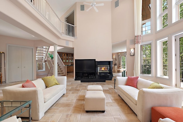 621 Chatfield Rd, New Lenox, IL 60451 - living room with a high ceiling, a ceiling fan, healthy amount of natural light, stairway, and stone tile flooring