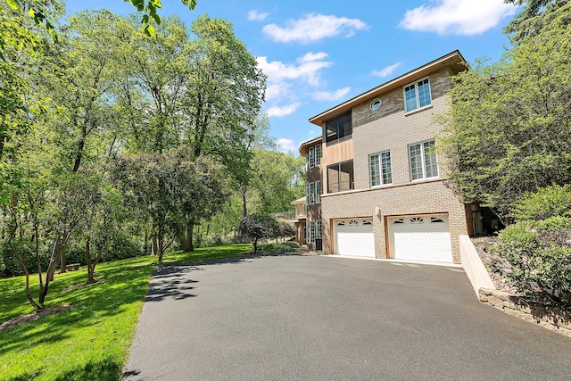 621 Chatfield Rd, New Lenox, IL 60451 - view of home's exterior with asphalt driveway, an attached garage, brick siding, and a yard