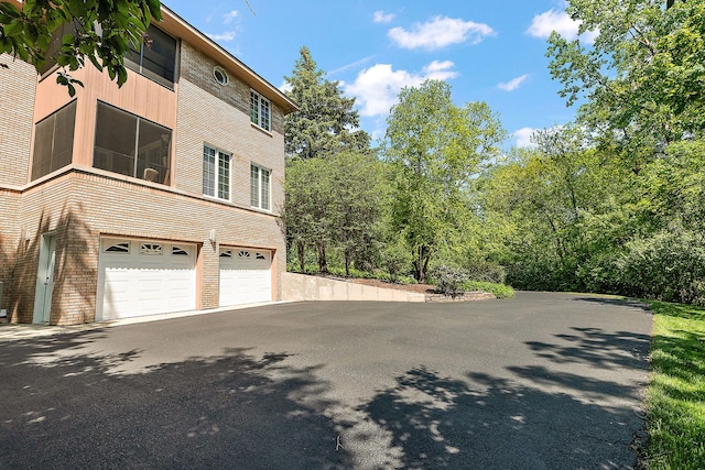 621 Chatfield Rd, New Lenox, IL 60451 - view of side of home with an attached garage and asphalt driveway