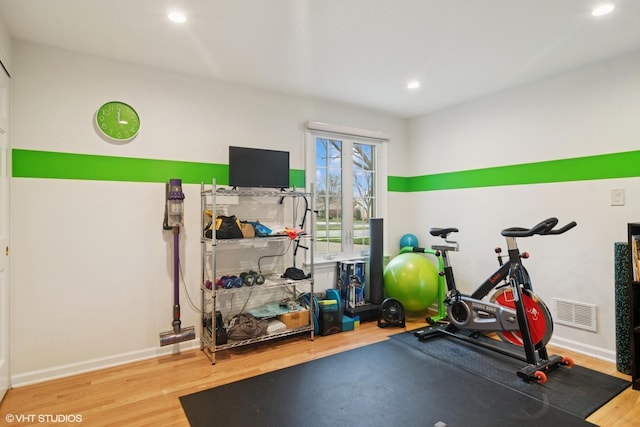 workout area featuring visible vents, baseboards, recessed lighting, and wood finished floors