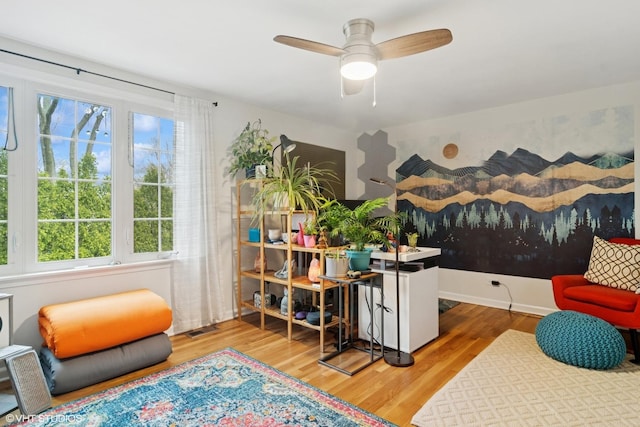 interior space featuring visible vents, a ceiling fan, and wood finished floors