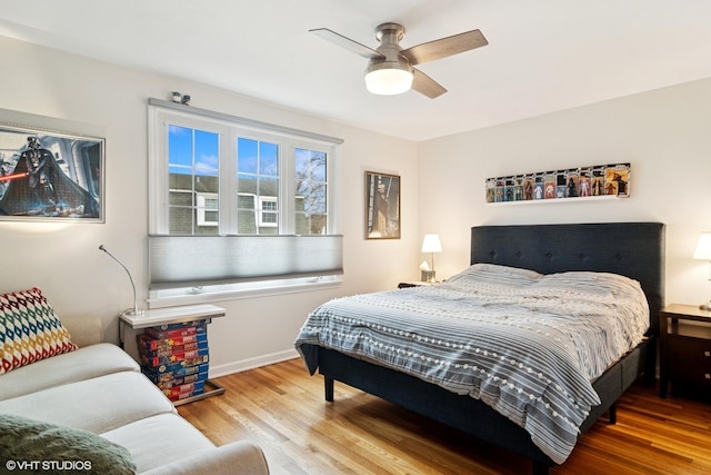 bedroom with baseboards, a ceiling fan, and wood finished floors