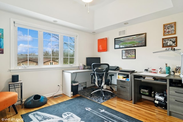 home office featuring visible vents and light wood-style flooring