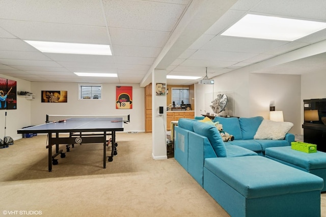 rec room featuring light carpet, baseboards, and a drop ceiling