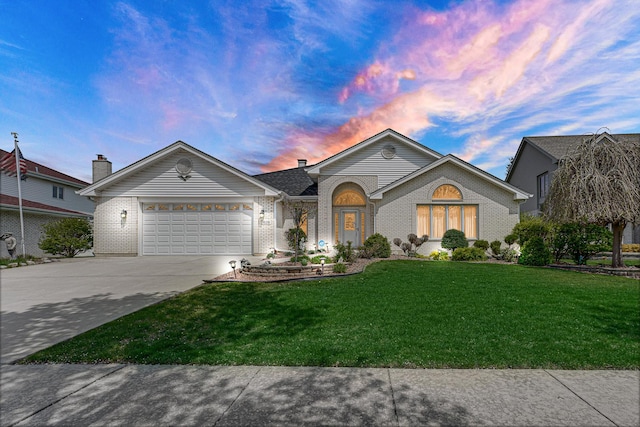 ranch-style home featuring brick siding, an attached garage, a yard, and concrete driveway