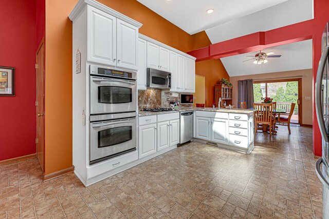 kitchen with baseboards, a high ceiling, stainless steel refrigerator with ice dispenser, and white cabinetry