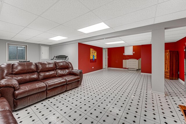 finished below grade area with baseboards and a drop ceiling