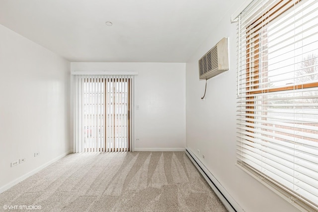 spare room featuring carpet, baseboards, a wall mounted AC, and a baseboard radiator