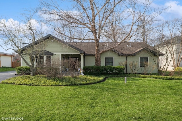 single story home with a front yard and driveway