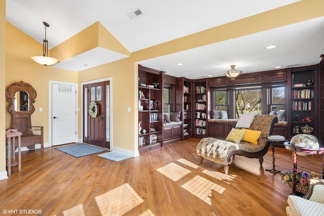 foyer entrance with light wood-style floors, vaulted ceiling, visible vents, recessed lighting, and baseboards
