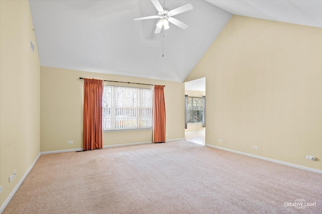 empty room with high vaulted ceiling, ceiling fan, baseboards, and carpet flooring