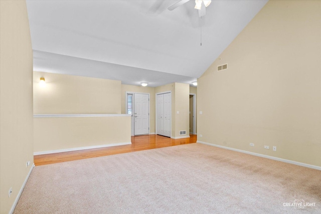carpeted spare room featuring baseboards, a ceiling fan, and visible vents