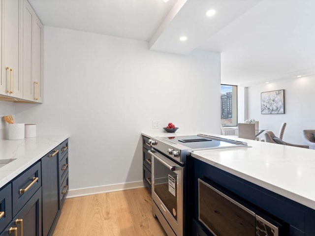 1355 N Sandburg Ter Unit 906D, Chicago, IL 60610 - kitchen featuring recessed lighting, baseboards, stainless steel electric stove, light wood-style floors, and a peninsula