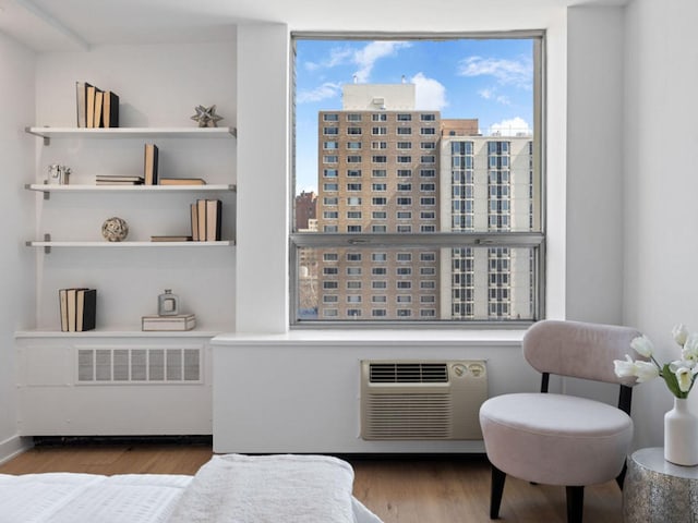 1355 N Sandburg Ter Unit 906D, Chicago, IL 60610 - living area featuring a wall mounted air conditioner and wood finished floors