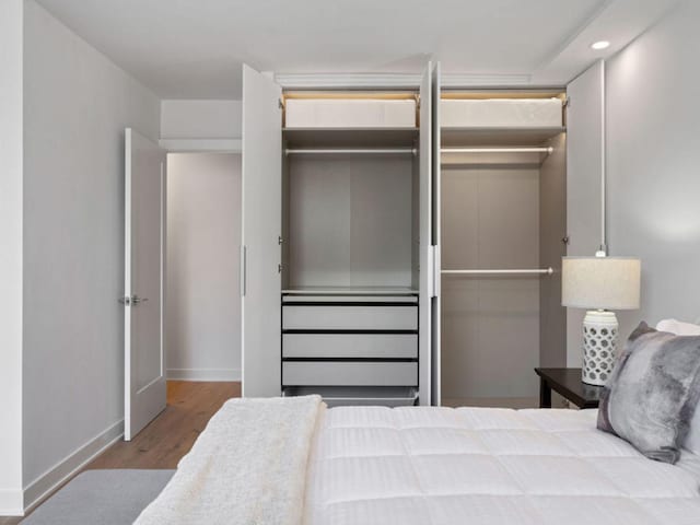 1355 N Sandburg Ter Unit 906D, Chicago, IL 60610 - bedroom featuring recessed lighting, baseboards, and wood finished floors