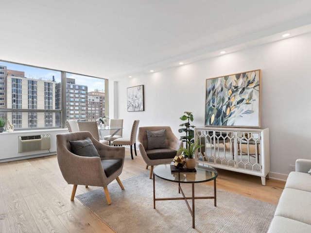 1355 N Sandburg Ter Unit 906D, Chicago, IL 60610 - living room featuring recessed lighting, an AC wall unit, baseboards, light wood finished floors, and a view of city