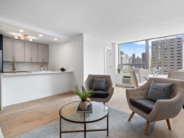 1355 N Sandburg Ter Unit 906D, Chicago, IL 60610 - living room featuring light wood finished floors, baseboards, a view of city, and recessed lighting