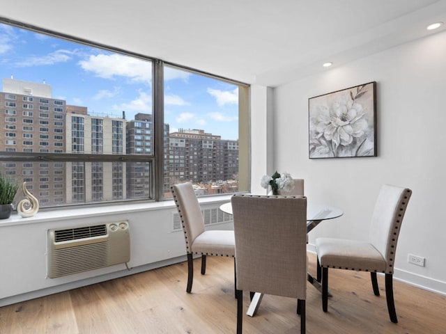 1355 N Sandburg Ter Unit 906D, Chicago, IL 60610 - dining space with a city view, baseboards, wood finished floors, recessed lighting, and a wall unit AC