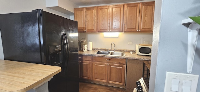 2508 Algonquin Rd Unit 5, Rolling Meadows, IL 60008 - kitchen featuring black fridge with ice dispenser, a sink, brown cabinetry, dark wood-style floors, and range