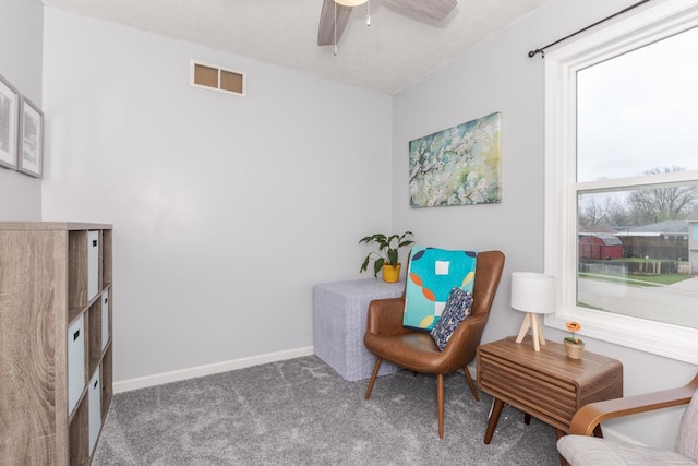 living area with carpet flooring, baseboards, a ceiling fan, and visible vents