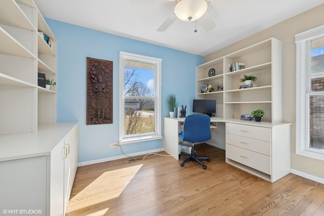 office area featuring baseboards, a wealth of natural light, and light wood-style flooring