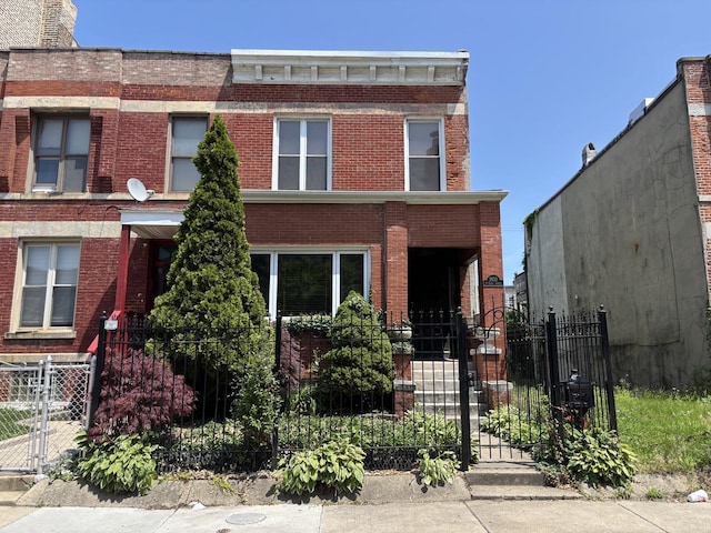 3833 S Giles Ave, Chicago, IL 60653 - view of front facade featuring a gate, brick siding, and a fenced front yard