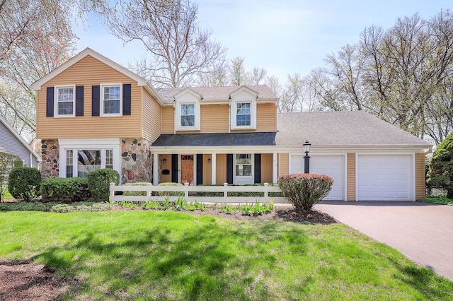 416 E Bauer Rd, Naperville, IL 60563 - view of front of home with a front lawn, a garage, covered porch, stone siding, and aphalt driveway