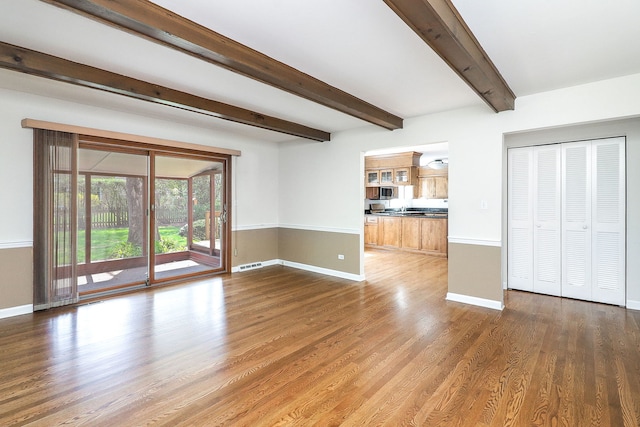 416 E Bauer Rd, Naperville, IL 60563 - unfurnished living room featuring beam ceiling, wood finished floors, visible vents, and baseboards